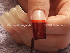 nail lacquer in the colour dark red with glitter